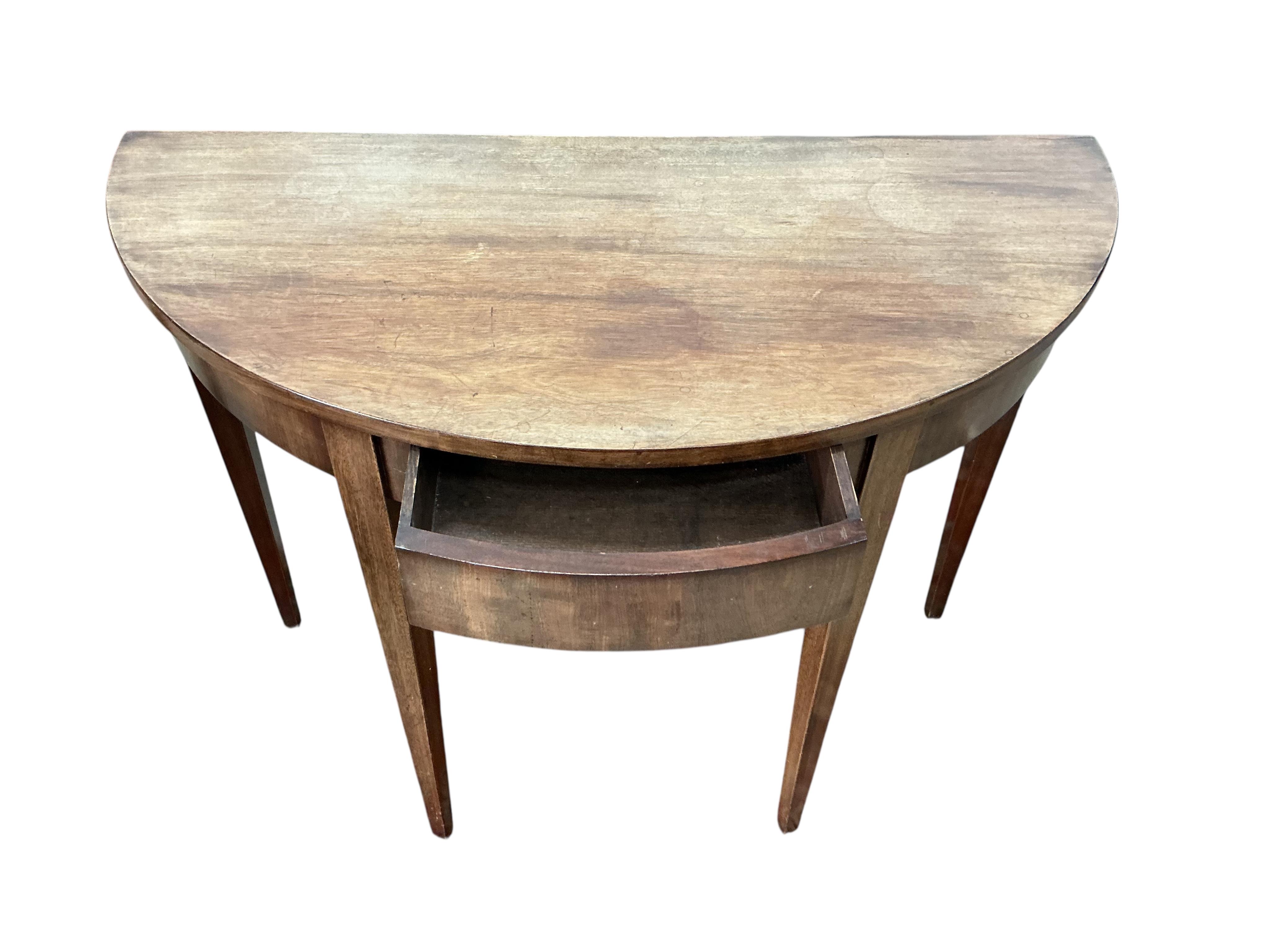 A pair of George III mahogany 'D' shaped tables, each fitted with a single drawer, each width 104cm, depth 50cm, height 76cm together with a pair of George III mahogany dining chairs
